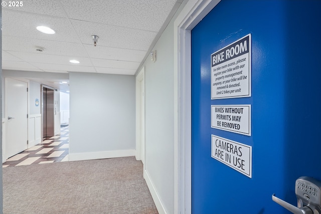 corridor with a paneled ceiling