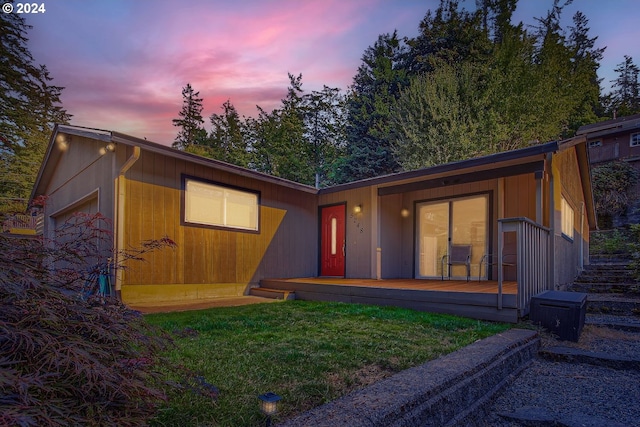 view of front of property with a yard and a wooden deck