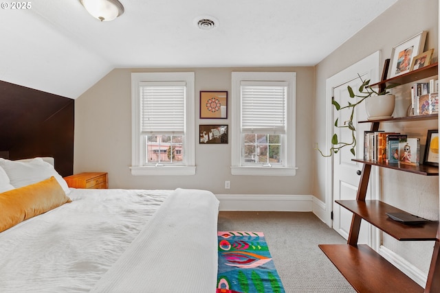 carpeted bedroom featuring multiple windows and lofted ceiling