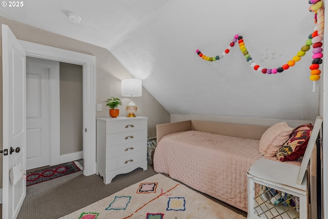 carpeted bedroom with vaulted ceiling