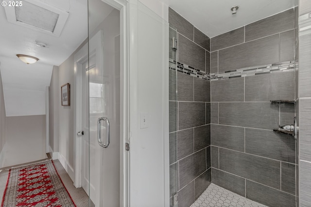 bathroom featuring lofted ceiling and a shower with shower door