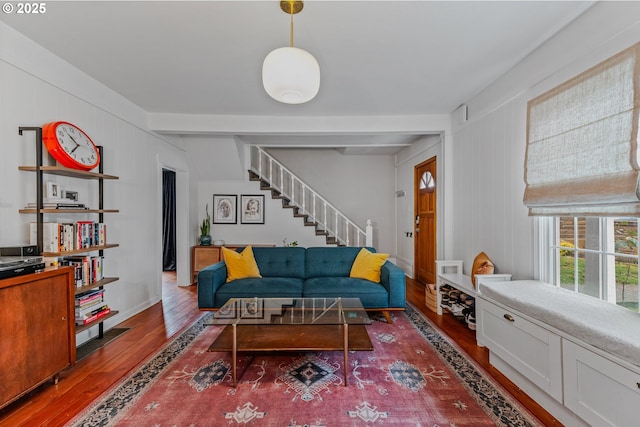 living room featuring beam ceiling and dark wood-type flooring