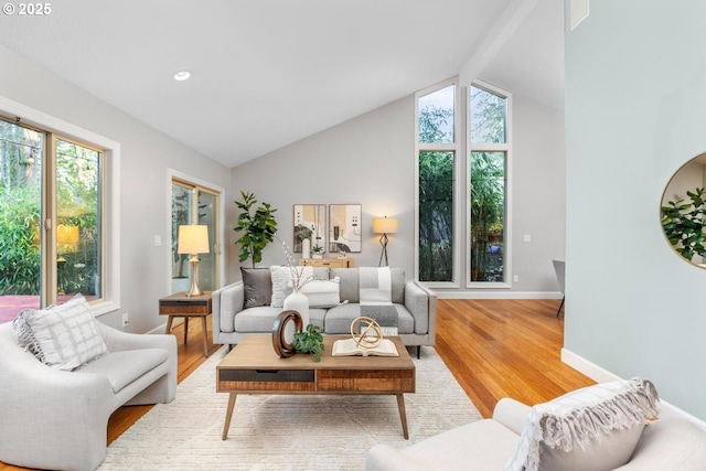 living room with light wood-type flooring and vaulted ceiling with beams