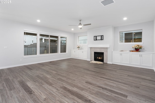 unfurnished living room featuring hardwood / wood-style floors and ceiling fan