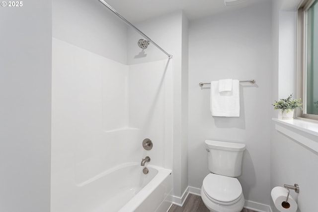 bathroom with shower / bath combination and toilet