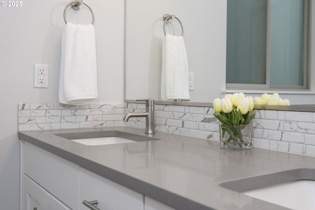 bathroom featuring vanity and backsplash