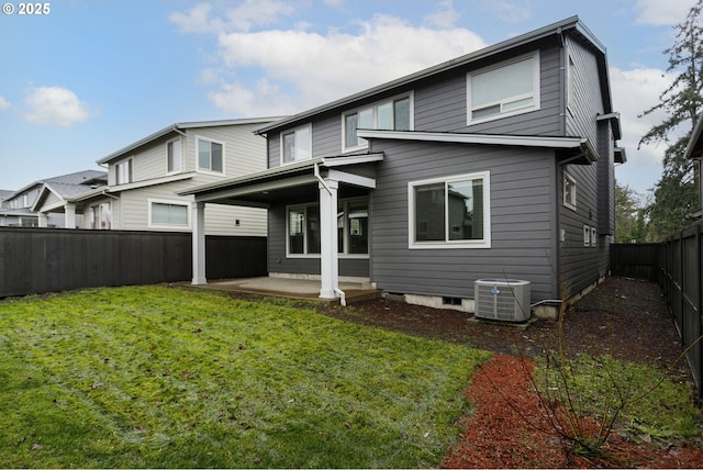 rear view of house with a yard, cooling unit, and a patio area