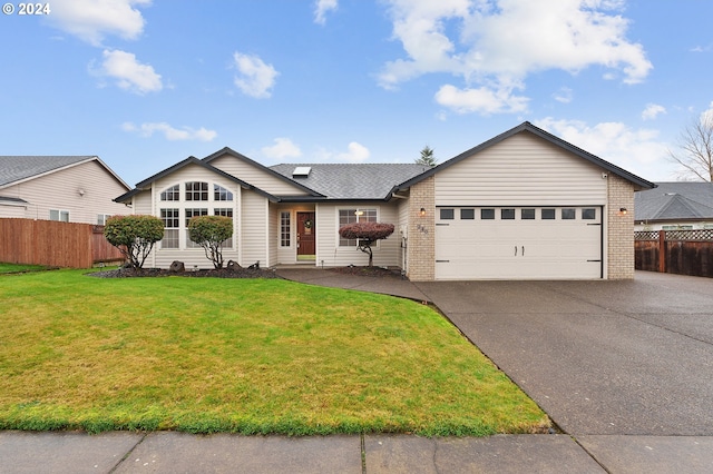 ranch-style home with a garage and a front yard