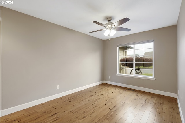 empty room with ceiling fan and light hardwood / wood-style floors