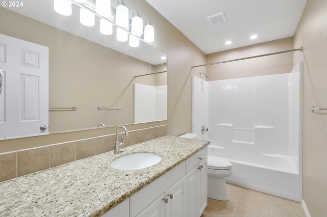 full bathroom with washtub / shower combination, tile patterned flooring, vanity, and toilet