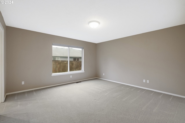 spare room with light colored carpet