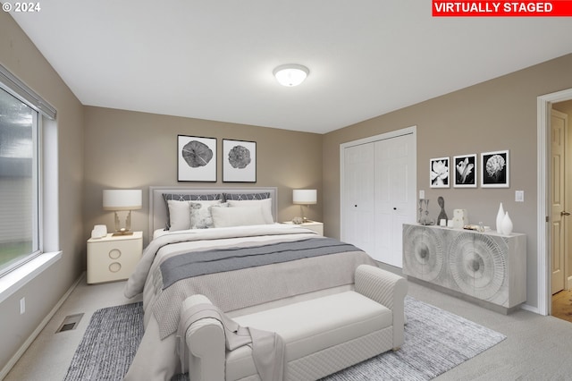 carpeted bedroom with a closet