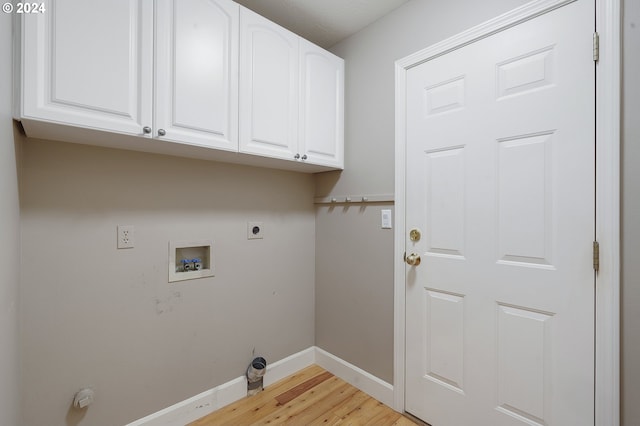 washroom with cabinets, hookup for a washing machine, light wood-type flooring, and hookup for an electric dryer