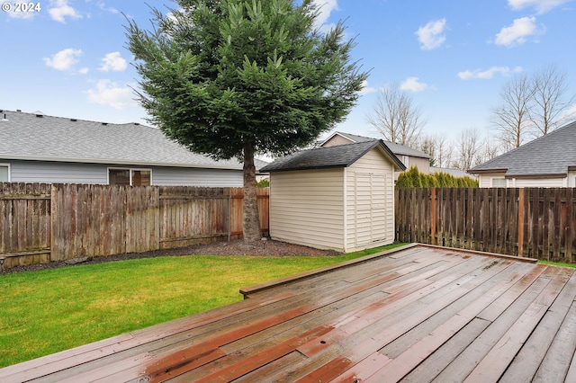 wooden terrace with a storage shed and a lawn