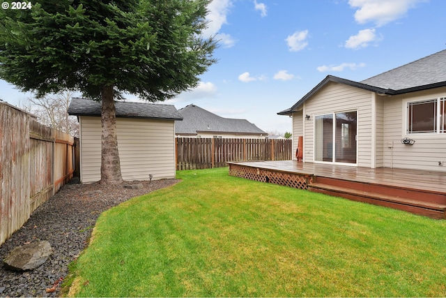 view of yard featuring a shed and a wooden deck