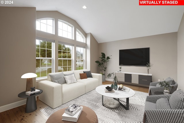 living room featuring light hardwood / wood-style floors and lofted ceiling