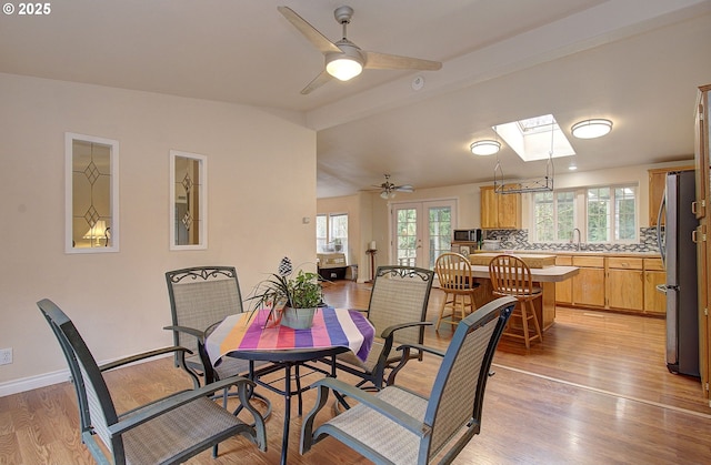 dining room featuring ceiling fan, plenty of natural light, and light wood-type flooring