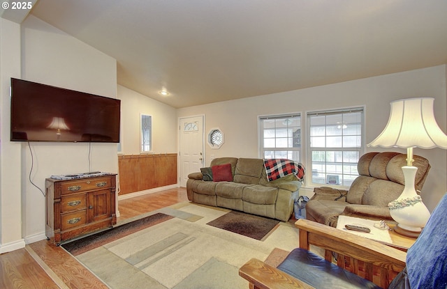 living room with light wood-type flooring and lofted ceiling