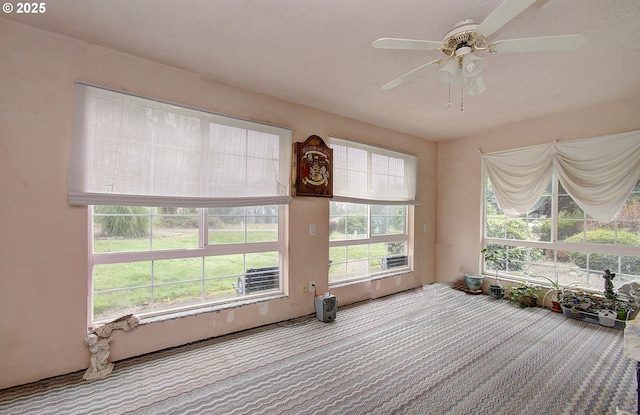 interior space with ceiling fan and a healthy amount of sunlight