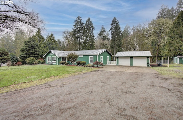 ranch-style house featuring a garage, a front lawn, and a shed