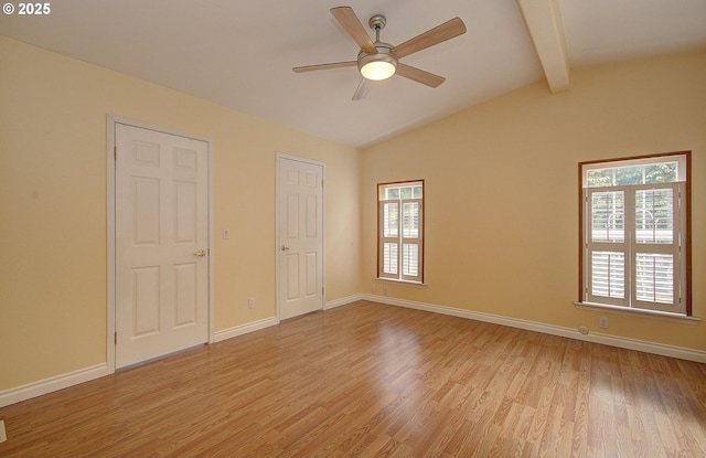 unfurnished bedroom featuring ceiling fan, light hardwood / wood-style floors, and vaulted ceiling with beams