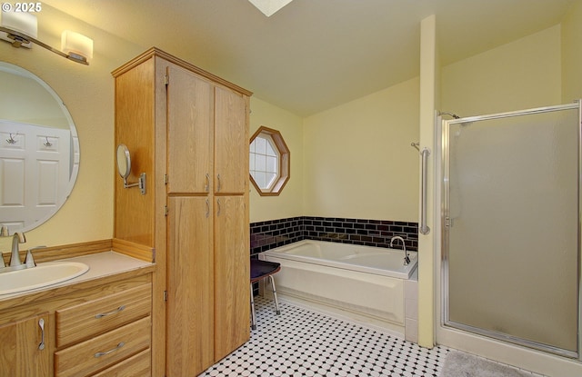 bathroom with plus walk in shower and vanity