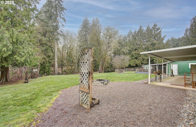 view of yard featuring an outdoor fire pit and a patio area