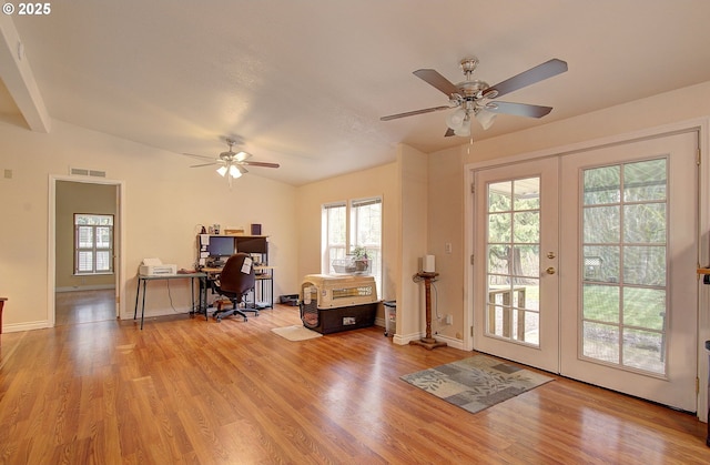 office area featuring lofted ceiling, french doors, ceiling fan, and light hardwood / wood-style floors