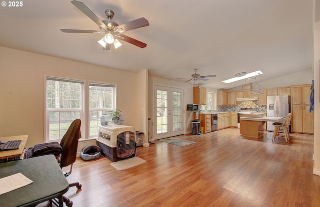 home office with lofted ceiling, light wood-type flooring, and ceiling fan