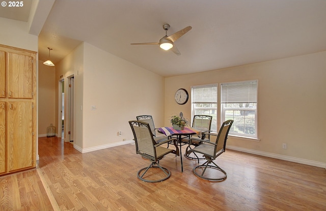 dining space with ceiling fan and light hardwood / wood-style flooring