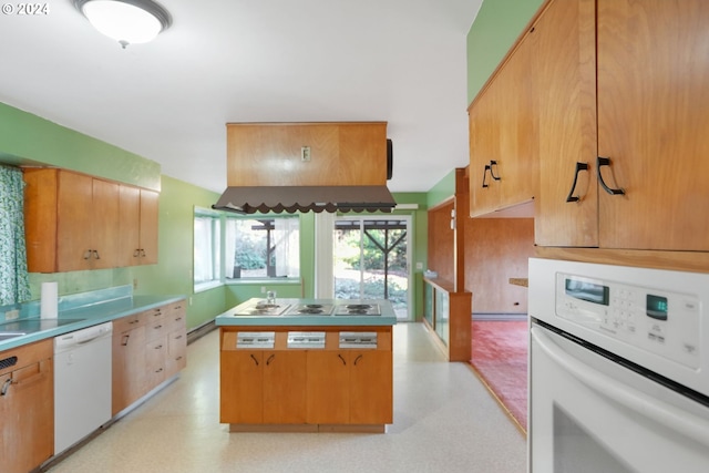 kitchen with white appliances and a baseboard radiator