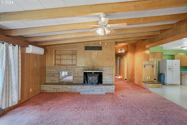 unfurnished living room with a wood stove, a wall mounted air conditioner, vaulted ceiling with beams, wood walls, and ceiling fan with notable chandelier