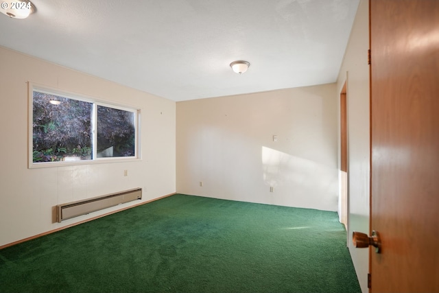 carpeted spare room featuring a baseboard heating unit