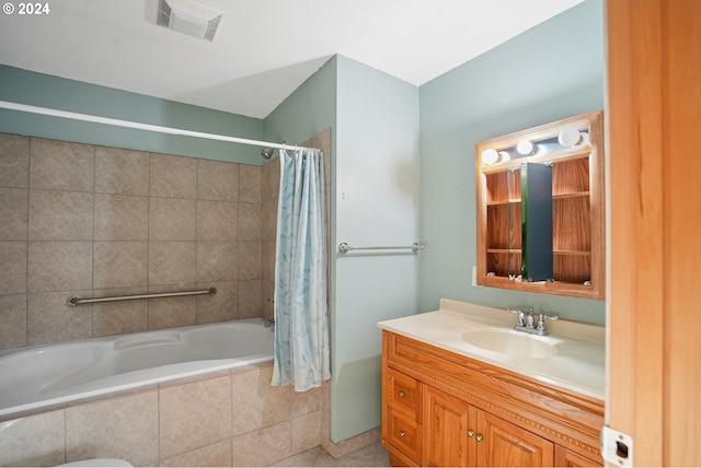 bathroom featuring tile patterned floors, vanity, and shower / tub combo