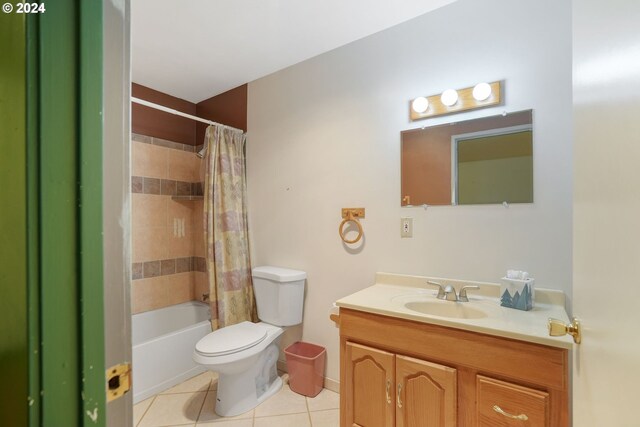 full bathroom featuring tile patterned floors, vanity, toilet, and shower / bathtub combination with curtain