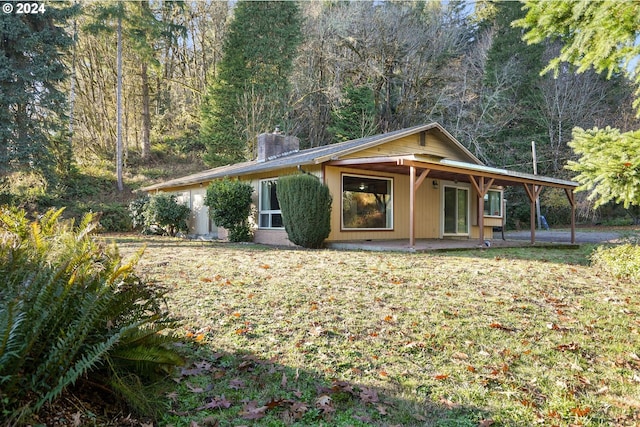 view of front of property with a front lawn and a patio area