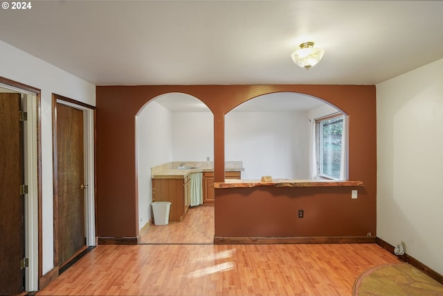 unfurnished room with light wood-type flooring