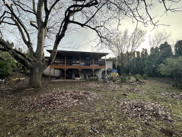 rear view of property with a wooden deck