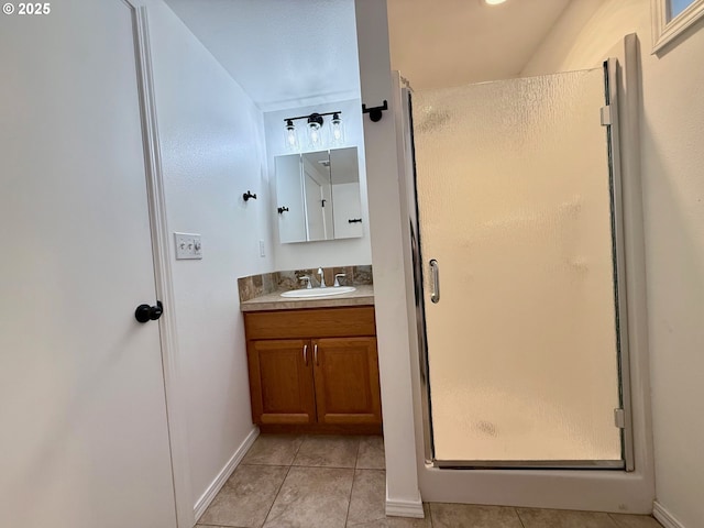 bathroom with vanity, tile patterned flooring, and a shower with door