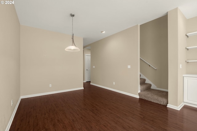 empty room with dark hardwood / wood-style flooring