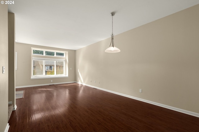 spare room featuring dark hardwood / wood-style flooring