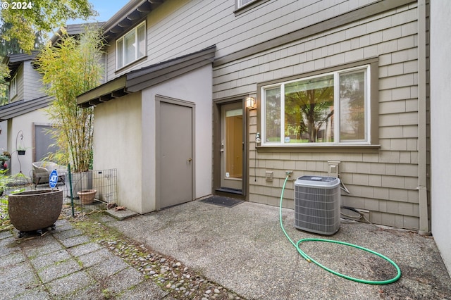 doorway to property with a patio area and cooling unit