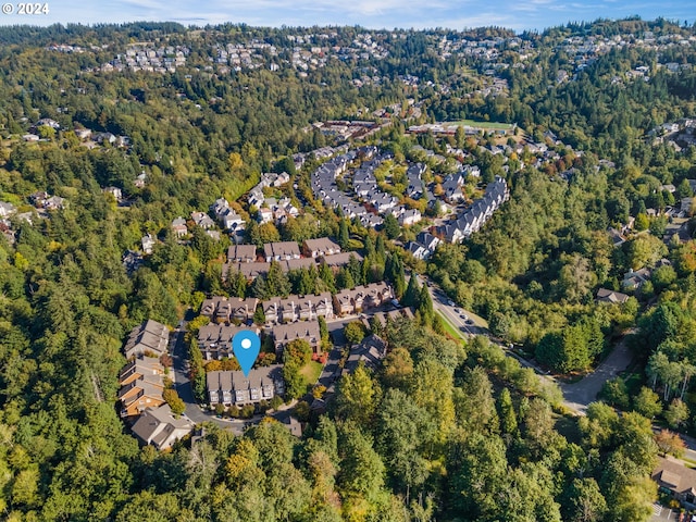 birds eye view of property featuring a forest view and a residential view