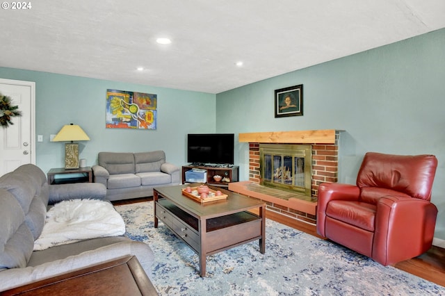 living room featuring wood-type flooring and a fireplace