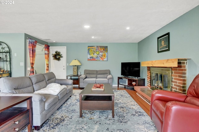 living room with a fireplace and light hardwood / wood-style flooring