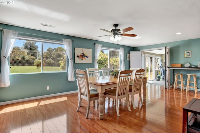 dining room with light hardwood / wood-style flooring and ceiling fan