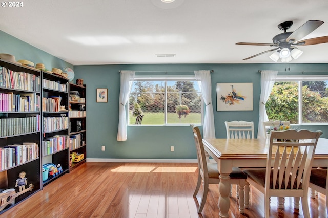 dining room with light wood-type flooring, plenty of natural light, and ceiling fan