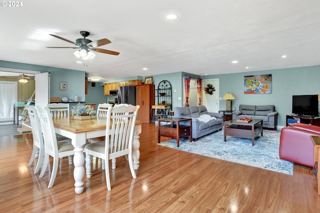 dining room with ceiling fan and light wood-type flooring