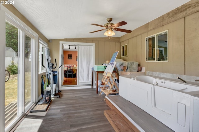 sunroom / solarium with ceiling fan and vaulted ceiling