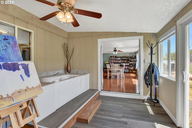 mudroom featuring dark wood-type flooring and lofted ceiling